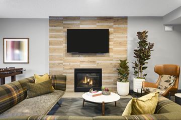 Plymouth apartment for rent - a living room with a fireplace and a tv above it