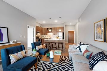 Apple Valley apartment for rent - a living room and kitchen with a couch and a table