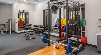 A gym with weights and other equipment in a building