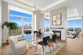 Minneapolis townhouse for rent - a dining room with a glass table and chairs and a fireplace at Expo, Minneapolis Minnesota