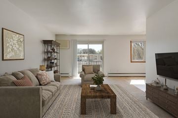Roseville apartment for rent - A living room with a grey couch and a wooden coffee table.