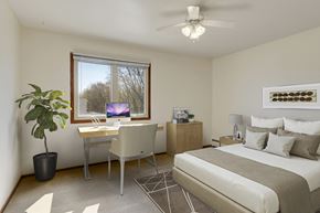 Roseville apartment for rent - a bedroom with a bed and a desk with a computer at Hamline Terrace, Roseville, MN