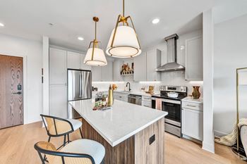A modern kitchen with a white countertop and a large island.
