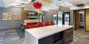Eden Prairie apartment for rent - Community Room with seating, a full kitchen, and lounge chairs at Eden Commons in Eden Prairie, MN 55344