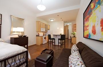 St. Paul apartment for rent - a living room and kitchen with a couch and a table