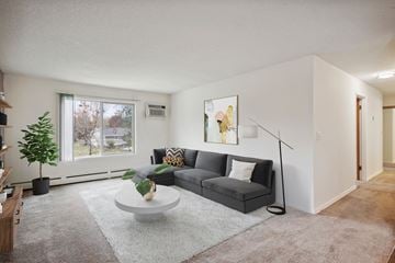 Oakdale apartment for rent - a living room with a grey couch and a white coffee table