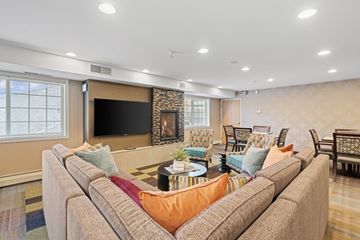 Rogers apartment for rent - A living room with a large couch and a flat screen TV.