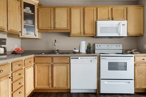 St. Louis Park apartment for rent - a kitchen with white appliances and wooden cabinets  at Park Pointe, Minnesota, 55426