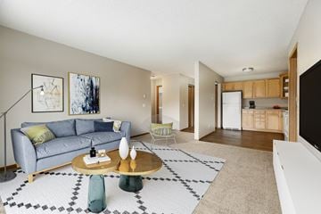 St. Louis Park apartment for rent - a living room with a couch and a coffee table in front of a flat screen tv