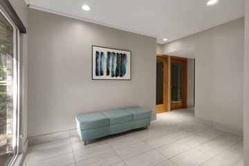 Bloomington apartment for rent - a living room with a blue couch and a painting on the wall