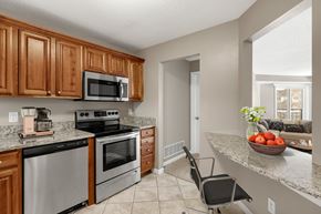 Lilydale apartment for rent - Kitchen with stainless steel appliances and quartz countertops at The Riverwood in Lilydale, MN 55118
