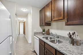 New Brighton apartment for rent - an empty kitchen with wood cabinets and a white refrigerator and sink at Silver Lake, New Brighton, 55112