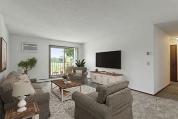 Maplewood apartment for rent - A living room with a grey carpet and a flat screen TV mounted on the wall.