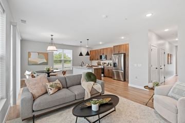 Rogers townhouse for rent - A modern living room with a grey sofa and a black coffee table.