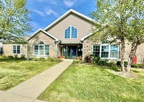 Lafayette triplex for rent - a house with a sidewalk and trees in front of it at Hawthorne Properties in Lafayette, IN 47905