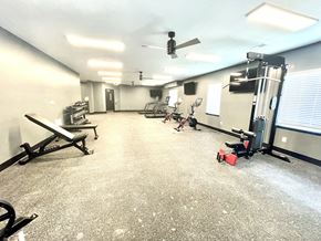 Lafayette apartment for rent - a large fitness room with exercise equipment and a ceiling fan at Murdock Gardens Apartments, Lafayette, IN 47904