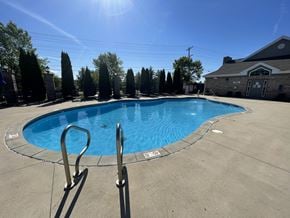Lafayette triplex for rent - a resort style pool is shown in front of a house at Hawthorne Properties in Lafayette, IN 47905