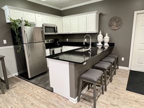 Lafayette triplex for rent - A kitchen with a black counter top and white cabinets at Shenandoah Properties in Lafayette, Indiana, 47905