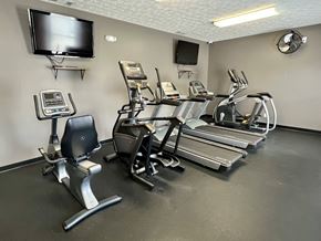 Lafayette triplex for rent - A gym with treadmills, elliptical machines, and a television at Shenandoah Properties in Lafayette, IN 47905
