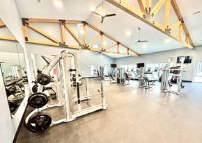 Lafayette triplex for rent - A gym with a variety of equipment including a weight rack and a squat rack.at Concord Crossing, Lafayette Indiana  