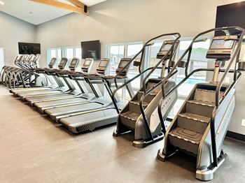 A gym with treadmills lined up.