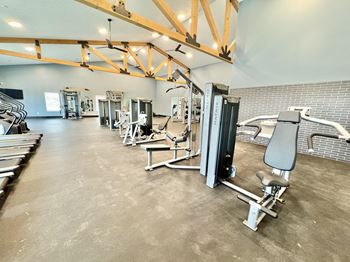 A gym with a variety of equipment including a leg press machine.