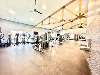 A gym with a variety of exercise equipment.