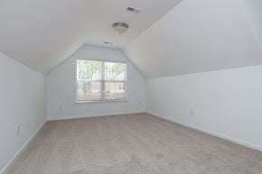 Fountain Inn townhouse for rent - a spacious attic room with white walls and a window