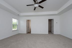 Fountain Inn townhouse for rent - a living room with white walls and a ceiling fan