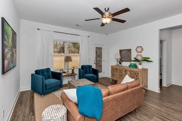 Madison triplex for rent - A living room with a brown couch and blue chairs.