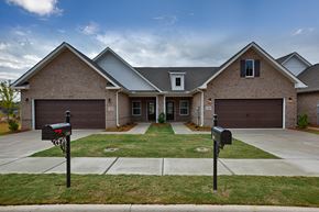 Madison triplex for rent - A house with a grey roof and a brown brick exterior.