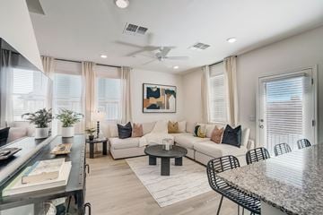 Surprise townhouse for rent - A modern living room with a white couch and a painting on the wall.