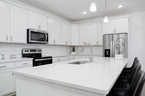 Chattanooga townhouse for rent - A modern kitchen with white cabinets and a white countertop.