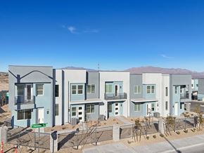 Las Vegas townhouse for rent - A row of modern houses with blue and grey exteriors are shown in a residential area.