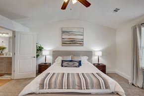 Franklin townhouse for rent - A bedroom with a large bed and a ceiling fan.