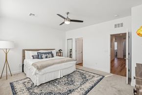 Las Vegas townhouse for rent - A bedroom with a large bed and a ceiling fan.