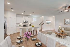 Franklin townhouse for rent - A modern dining room with a wooden table set for a meal.
