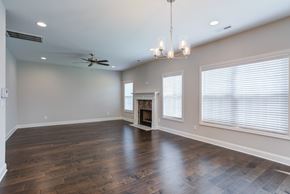 Knoxville townhouse for rent - A spacious room with a fireplace and a chandelier.