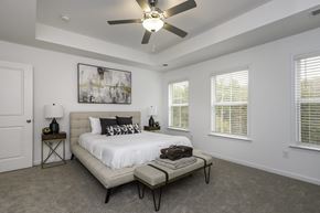 Fountain Inn townhouse for rent - a bedroom with a bed and a ceiling fan