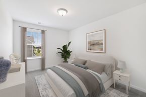 Spring Hill townhouse for rent - A bedroom with a large bed and a painting on the wall.