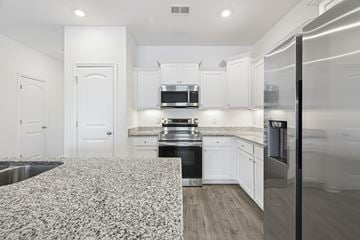 Spring Hill townhouse for rent - A kitchen with white cabinets and a patterned floor mat.