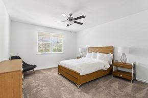 Stockbridge townhouse for rent - a bedroom with a bed and a ceiling fan