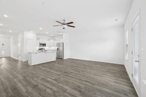 Spring Hill townhouse for rent - A spacious room with a ceiling fan and wooden flooring.