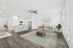 Spring Hill townhouse for rent - A living room with a couch, coffee table, and a dining table.