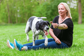 Waukesha apartment for rent - a woman sitting on the grass with her dog