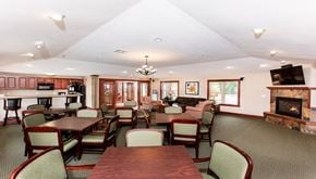 Greenfield apartment for rent - a dining room with tables and chairs and a fireplace