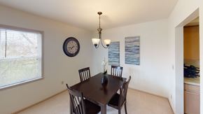 Brookfield apartment for rent - a dining room with a table and chairs and a clock on the wall