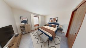 Greenfield apartment for rent - a bedroom with a bed and a tv in the corner of a room