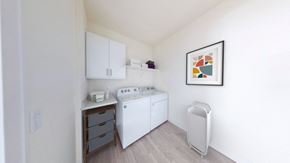 Brookfield apartment for rent - a small kitchen with white appliances and a painting on the wall