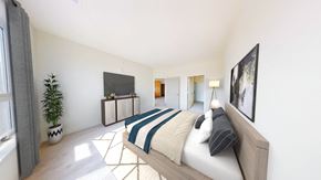 Brookfield apartment for rent - A bedroom with a bed, a television, and a potted plant.
